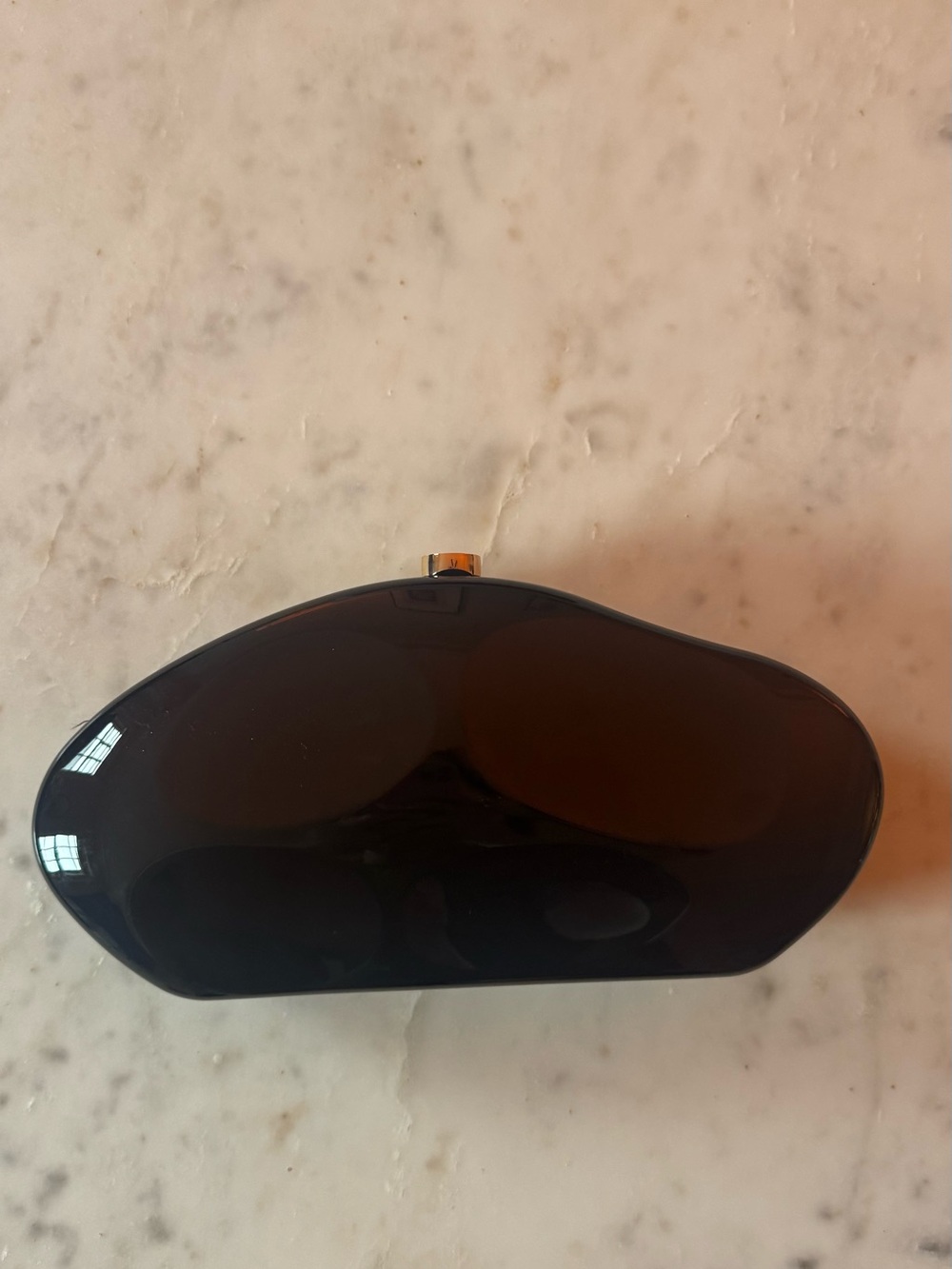 Sleek Black Oval Clutch